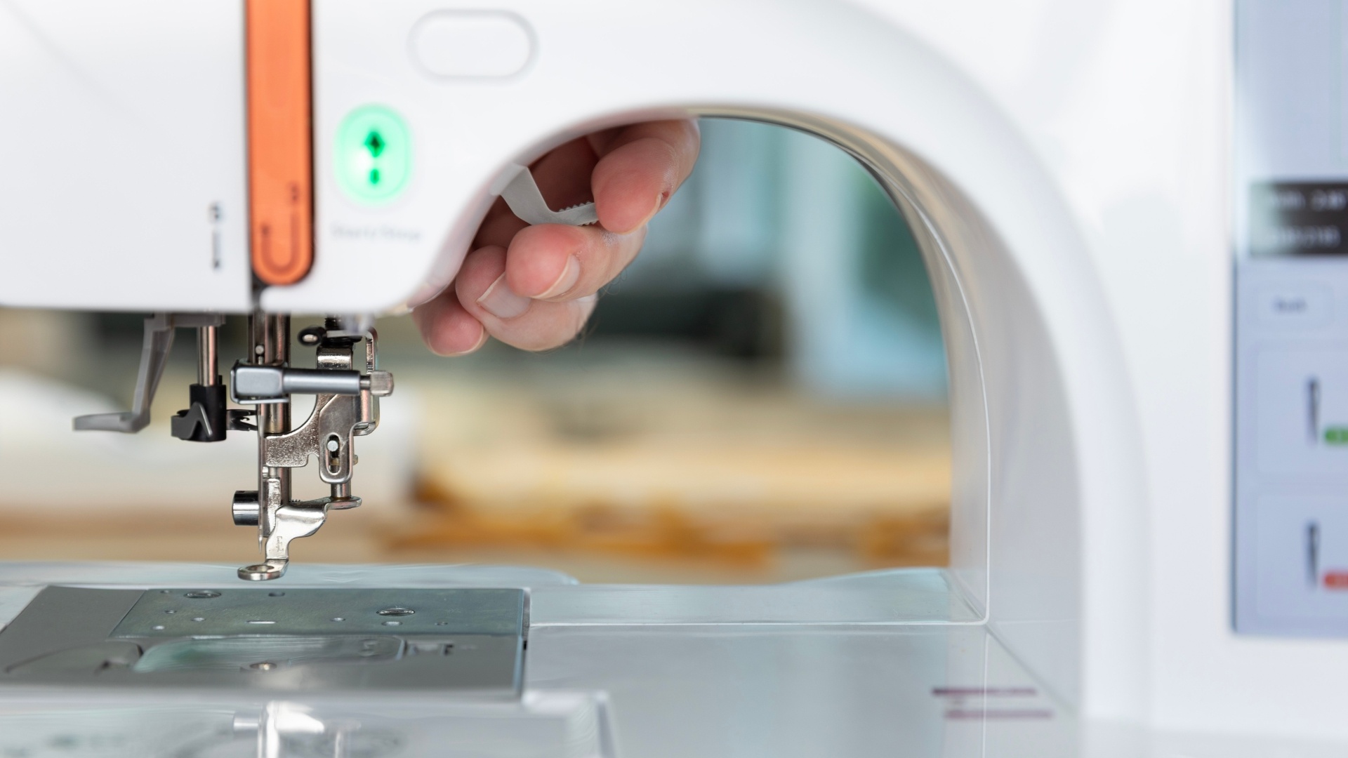 Raise the presser foot by using the handle on the embroidery machine