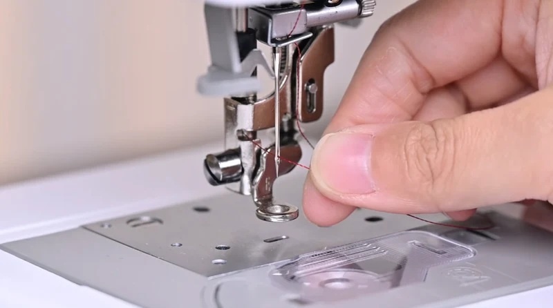 You can also put the thread through the eye of the needle manually