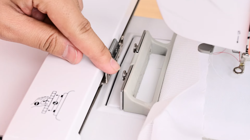 Align the notches on the embroidery hoop with the slot on the embroidery machine