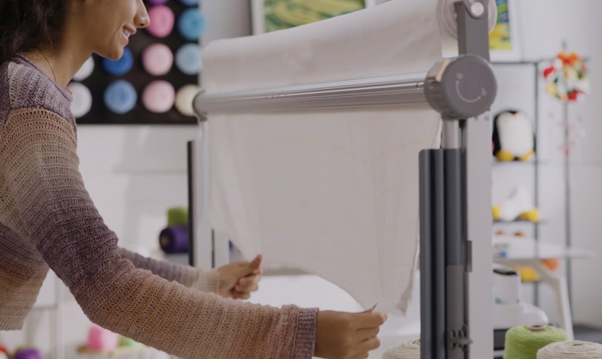 Woman pulling the fabric down on the Clawlab Tufting Frame H1