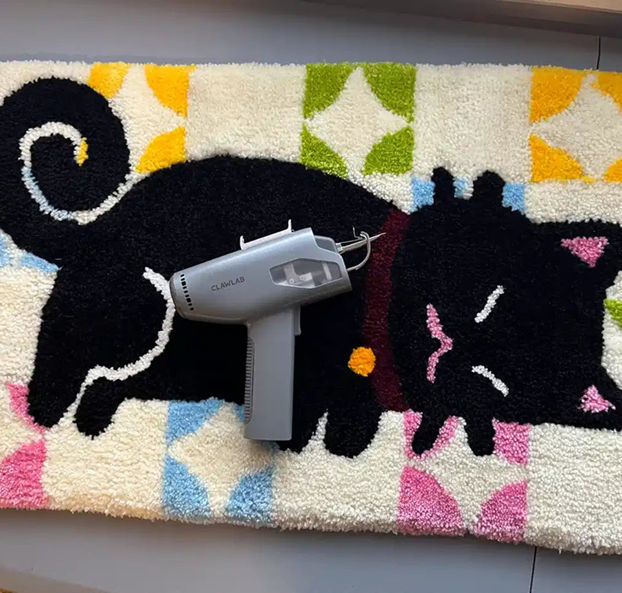 Tufted rug of a black cat sleeping.