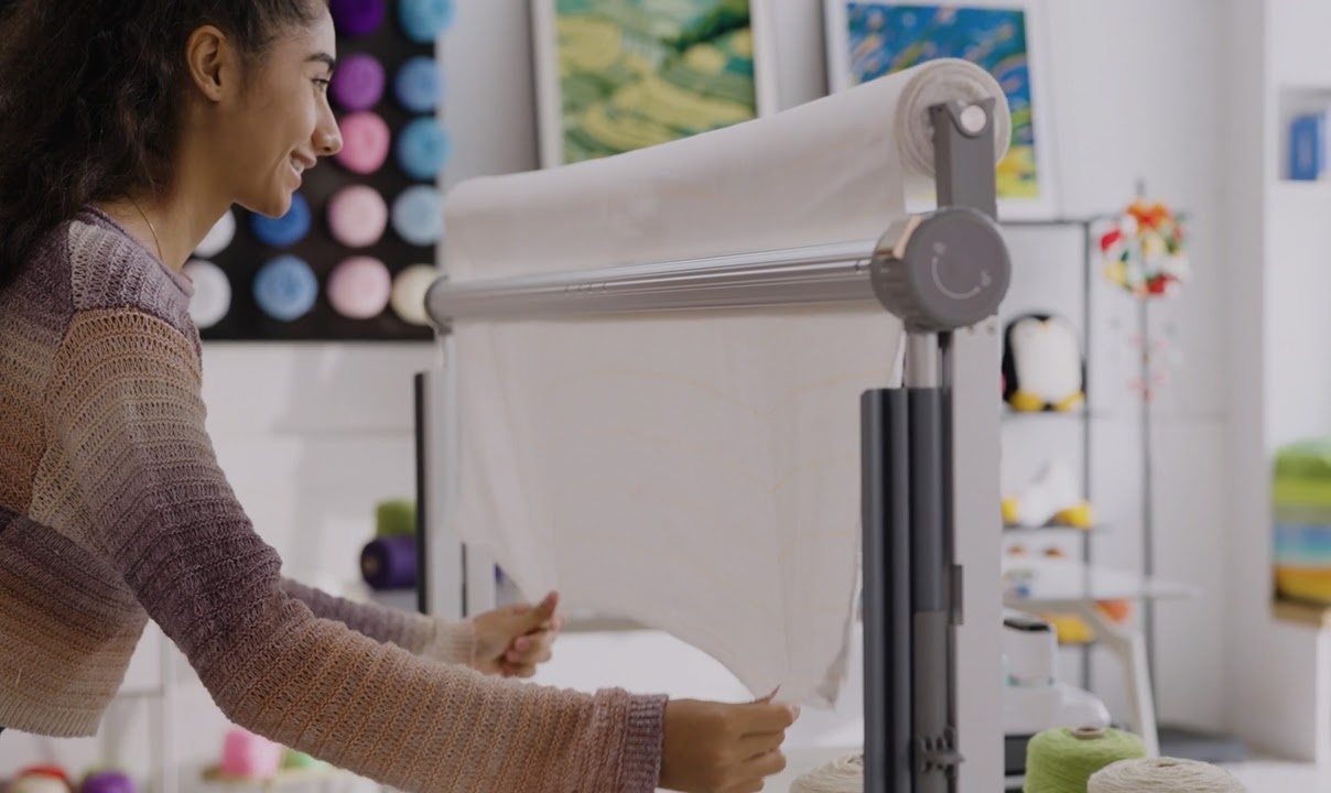 Woman pulling the fabric down on the Clawlab Tufting Frame H1.