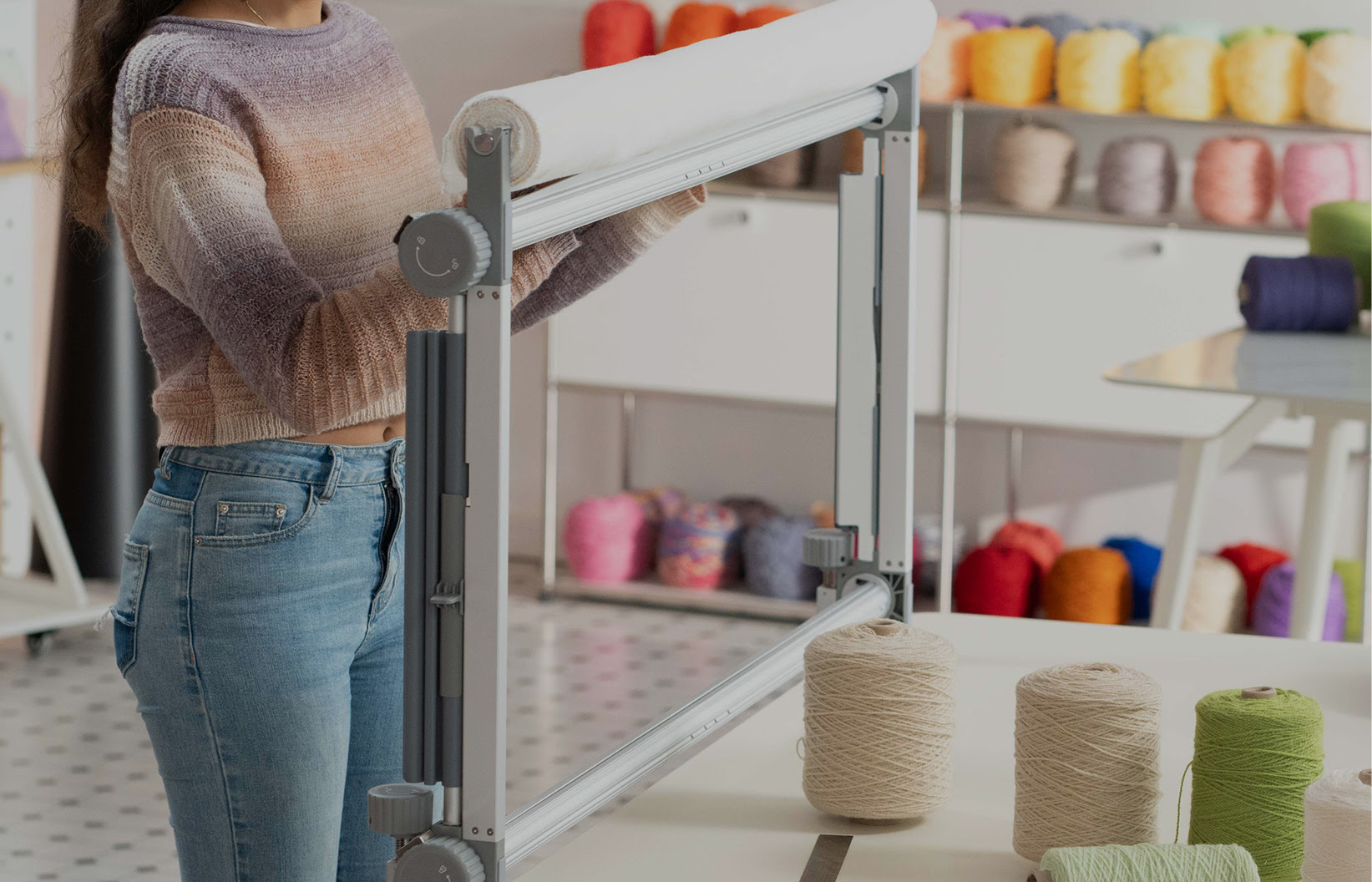 Woman pulling the fabric down on the Clawlab Tufting Frame H1.