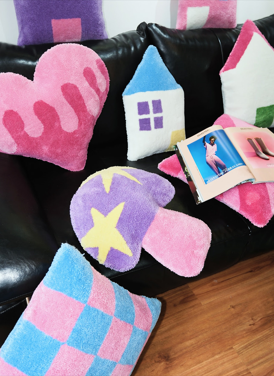 Tufted home décor in pink, blue, purple and white.
