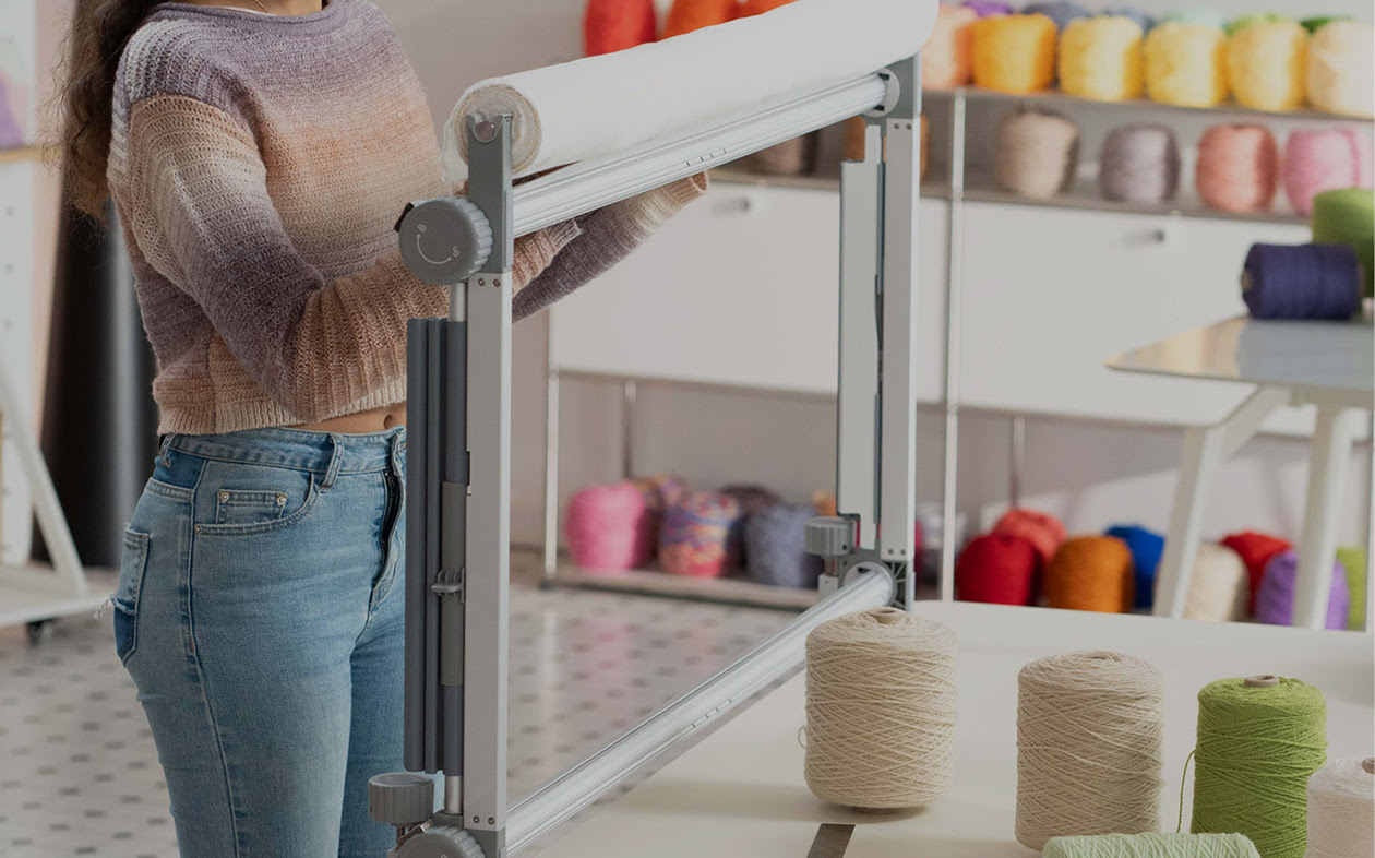 Woman pulling the fabric down on the Clawlab Tufting Frame H1.