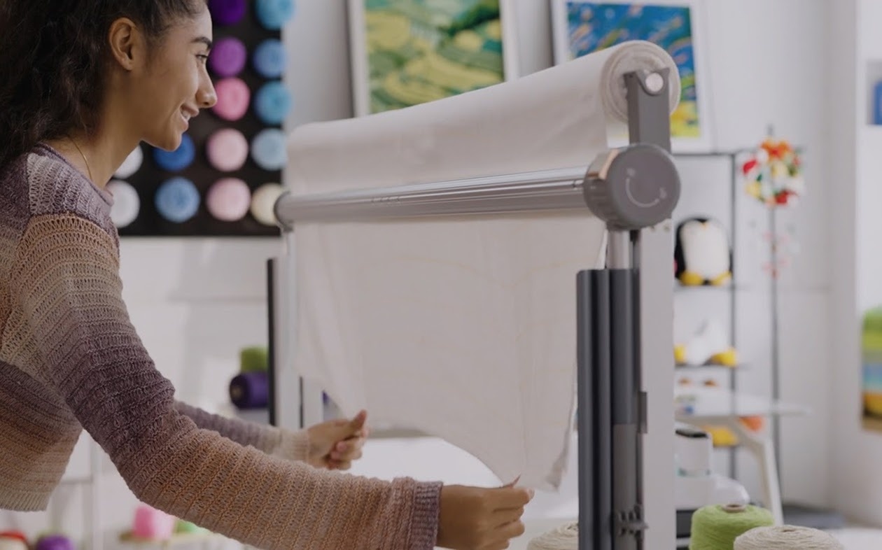 Woman pulling the fabric down on the Clawlab Tufting Frame H1.