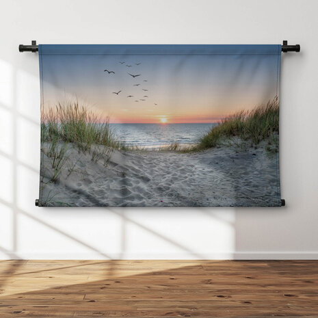 Zandduinen op het strand bij zonsondergang