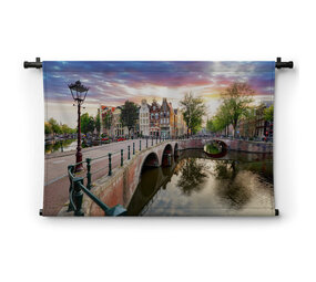 Amsterdamse grachtenpanden bij zonsondergang