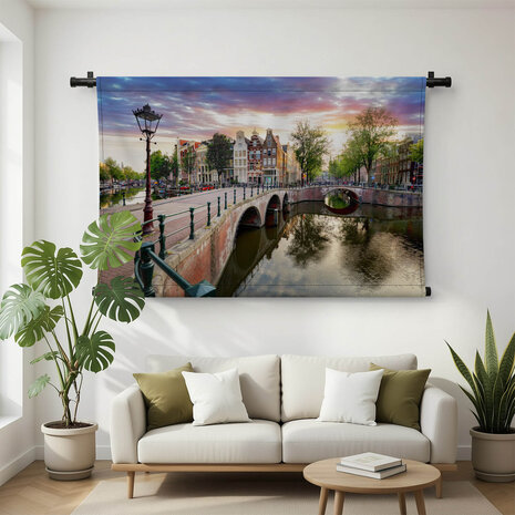 Amsterdamse grachtenpanden bij zonsondergang