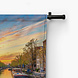 Amsterdamse skyline bij zonsondergang aan de gracht
