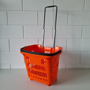 Winkelmand >Shop en Roll< op rubberen wielen oranje  Ral 2010 / pantone 158C, met uitschuifbaar handgreep van aluminium, hoogte 90cm.