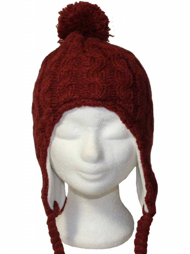 Gebreide pompon muts met vlechten roest oker Gebreide pompon muts met vlechten roest oker