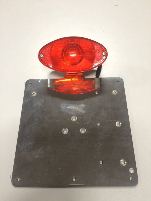 Universal plate holder including tail light