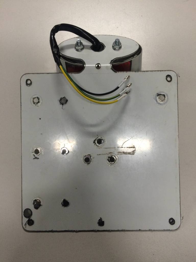 Universal plate holder including tail light