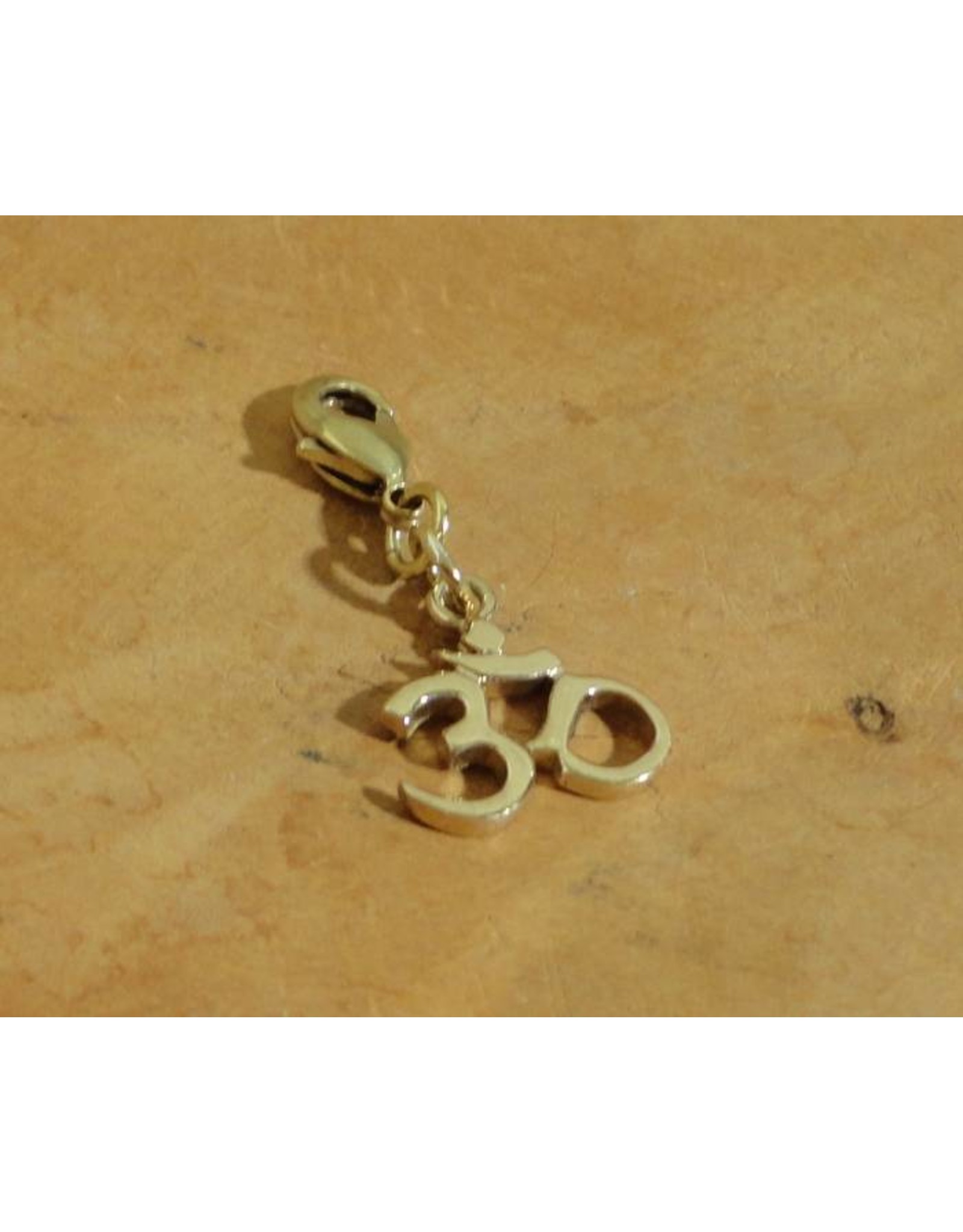 Shanti charm Ohm recycled brass