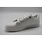 Witte sneaker met groene accenten