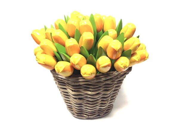 Yellow wooden tulips in a wicker basket