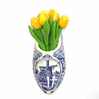 Yellow wooden tulips in a Delft blue clog