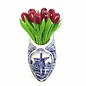 Red wooden tulips in a Delft blue clog