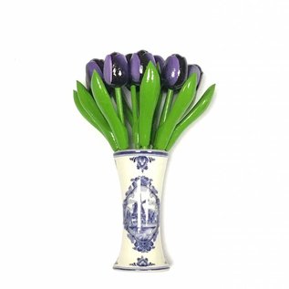 Small dark purple wooden tulips in a Delft blue vase