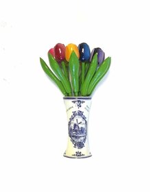 small wooden tulips in a Delft blue vase with logo