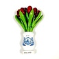 Red wooden tulips in a white wooden vase