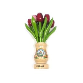 mixed red wooden tulips in a transparent wooden vase