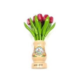 Red-white wooden tulips in a transparent wooden vase