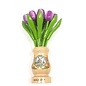 Purple wooden tulips in a transparent wooden vase