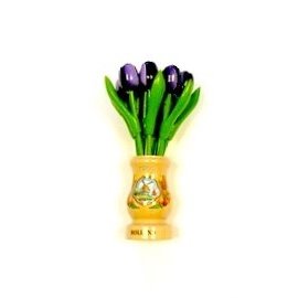 Dark purple wooden tulips in a transparent wooden vase