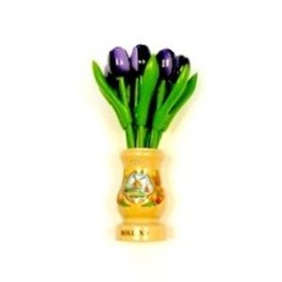 Dark purple wooden tulips in a transparent wooden vase