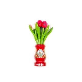 Mixed pink wooden tulips in a red wooden vase