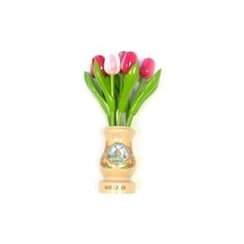 mixed pink wooden tulips in a transparent wooden vase