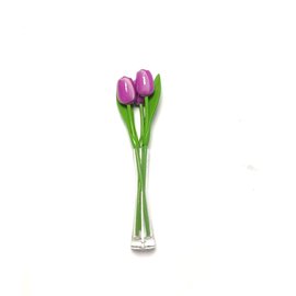 3 purple wooden tulips in a glass vase