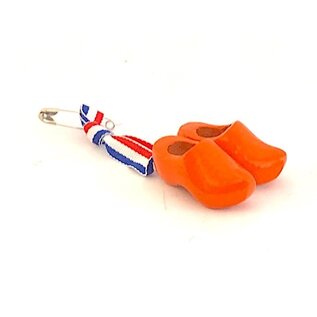Corsage met oranje klompjes