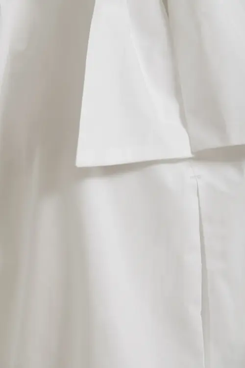 Essentiel Antwerp Off White Mouwloze top met strikkraag