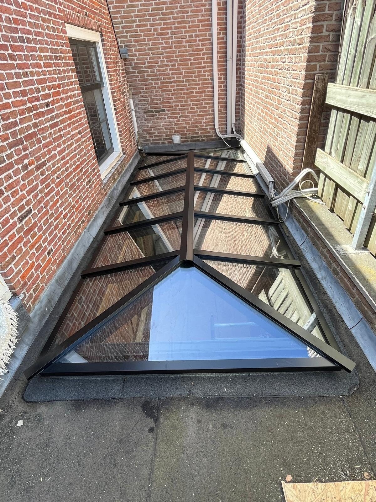 Zadeldak lichtstraat tussen bestaande bakstenen gevels