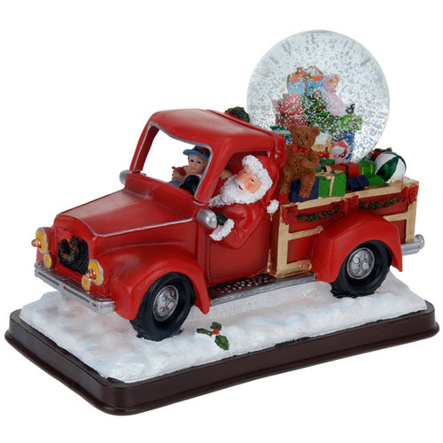 Kerstman met sneeuwbol in pickup truck Kerstman met sneeuwbol in pickup truck