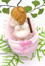 Slappende baby meisje in roze wieg spaarpot