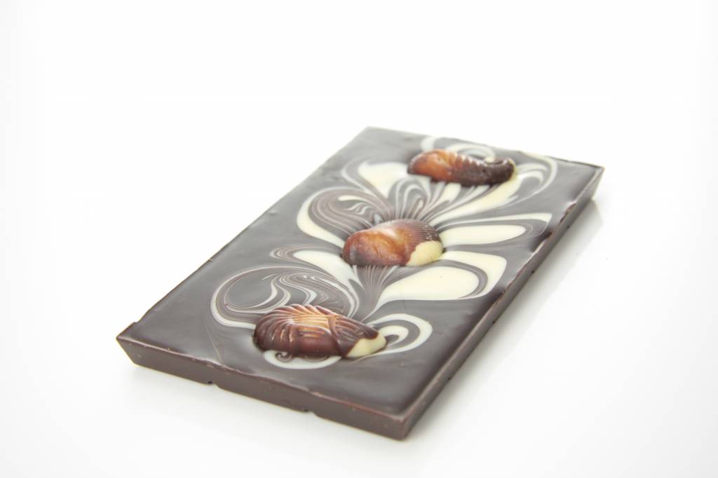 A dark chocolate bar with chocolate sea shells