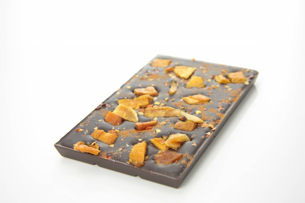 A bar of dark chocolate with mango and chili pepper