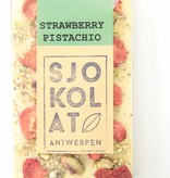 A bar of white chocolate with strawberry and pistachio nuts