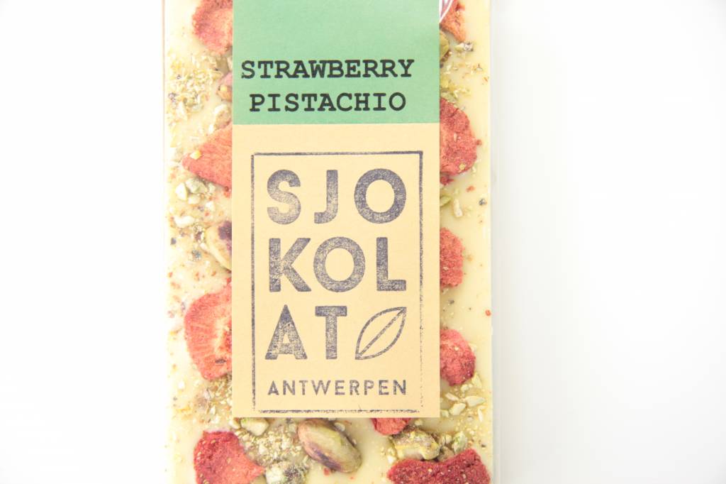 A bar of white chocolate with strawberry and pistachio nuts