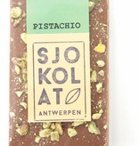 A bar of milk chocolate with pistachio nuts