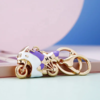 Schlüsselanhänger Gold Motorrad Weiß mit Lila