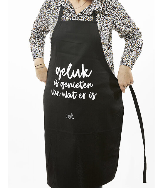 Schort met tekst 'Geluk is genieten van wat er is' in cadeauverpakking