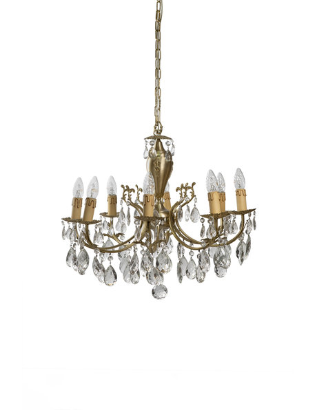 Old chandelier with 8 candles between crystal glass