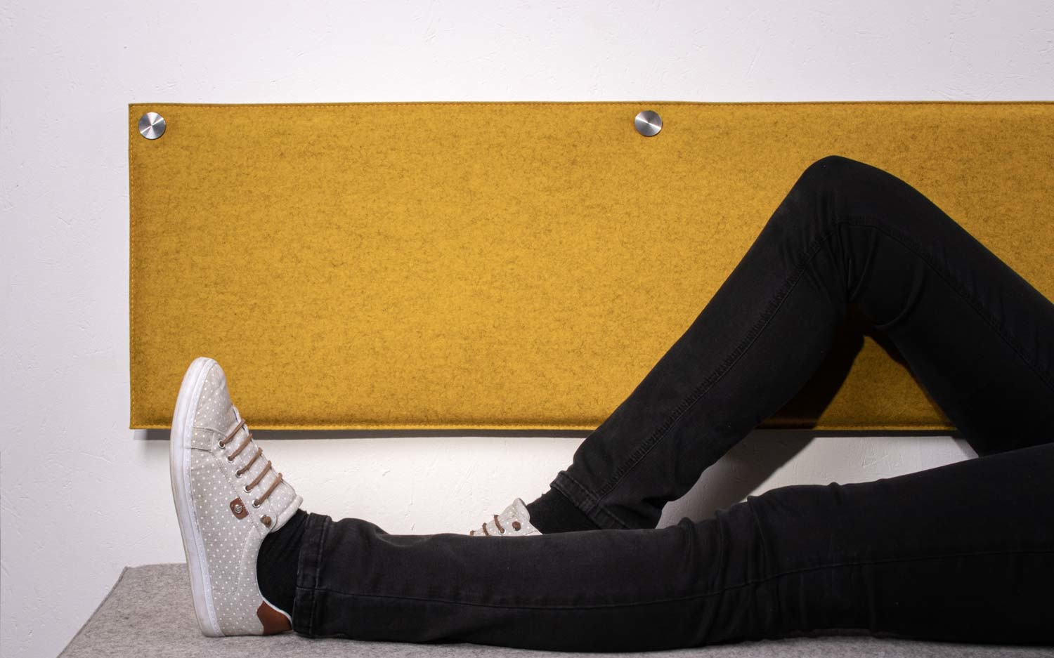Wall pillow with legs of person lying down