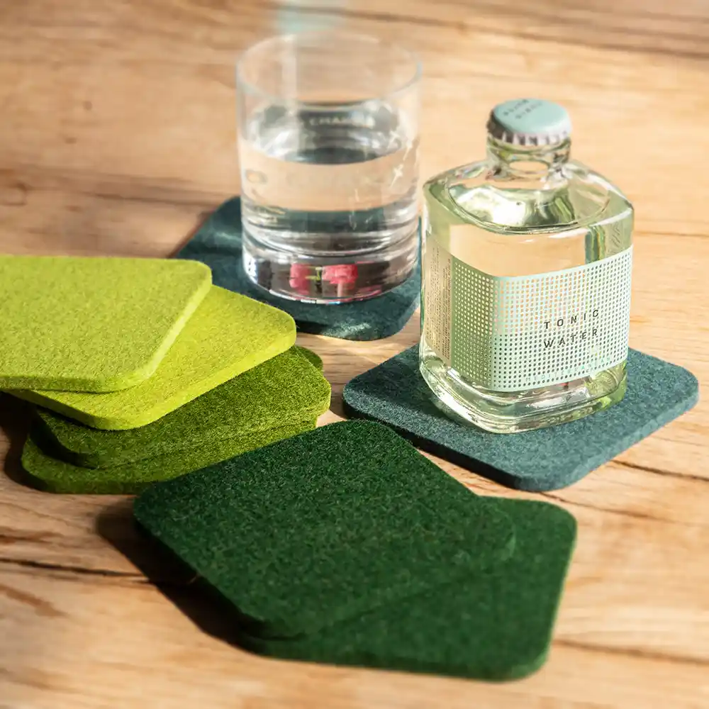 Felt coasters (set of 8) in various shades of green, with a glass and a small bottle
