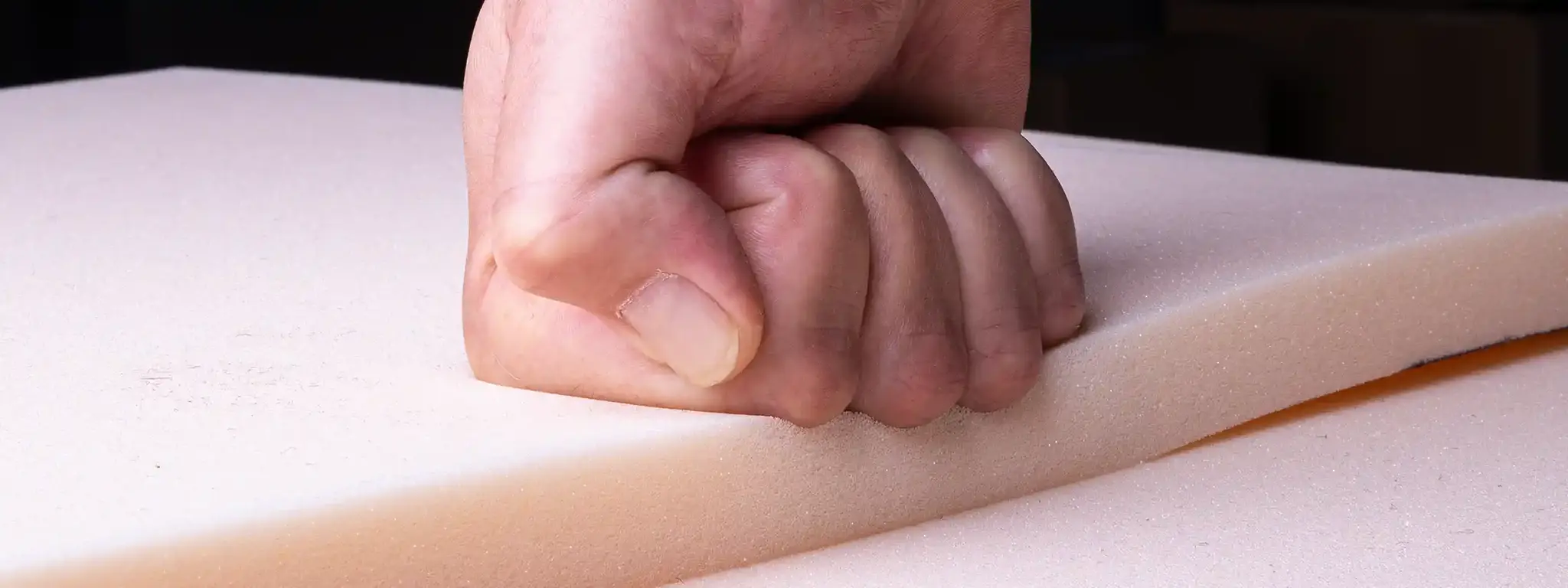 Fist pressing into a sheet of firm RG 50/78 comfort foam